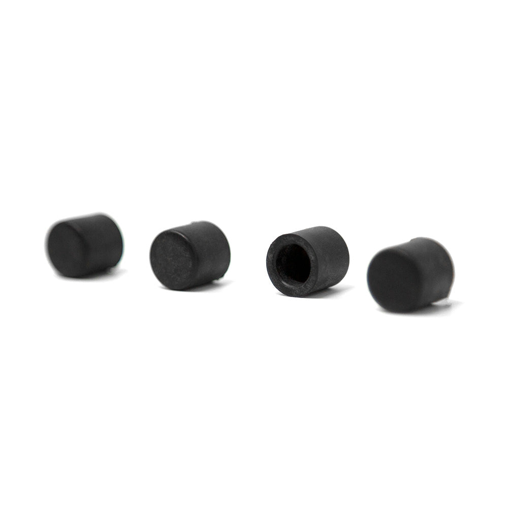 Four rubber end caps lying in a row.