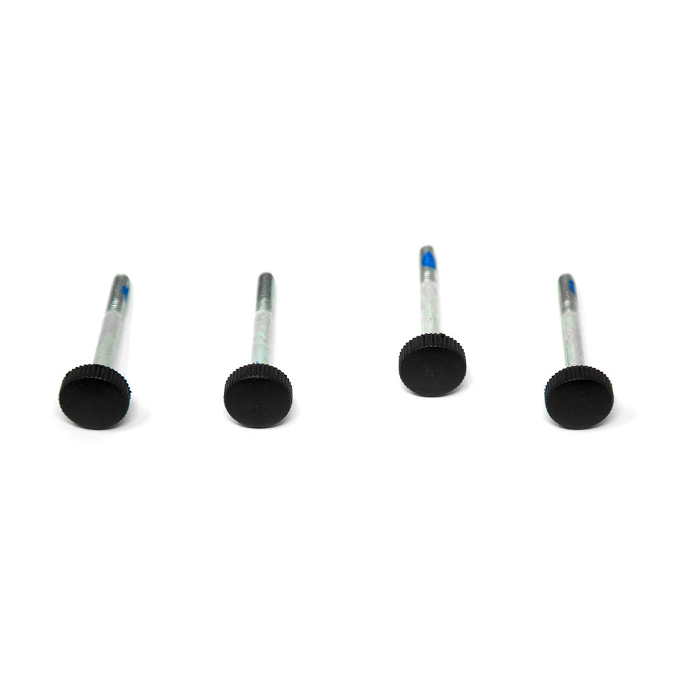 Four black bolts lying in a row.