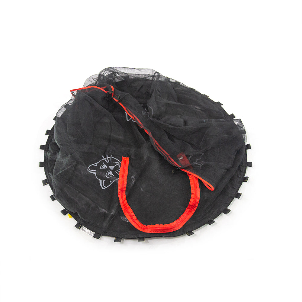 The animal print jump mat is laying on the ground with the enclosure net on top with the red zipper and a cat visible.