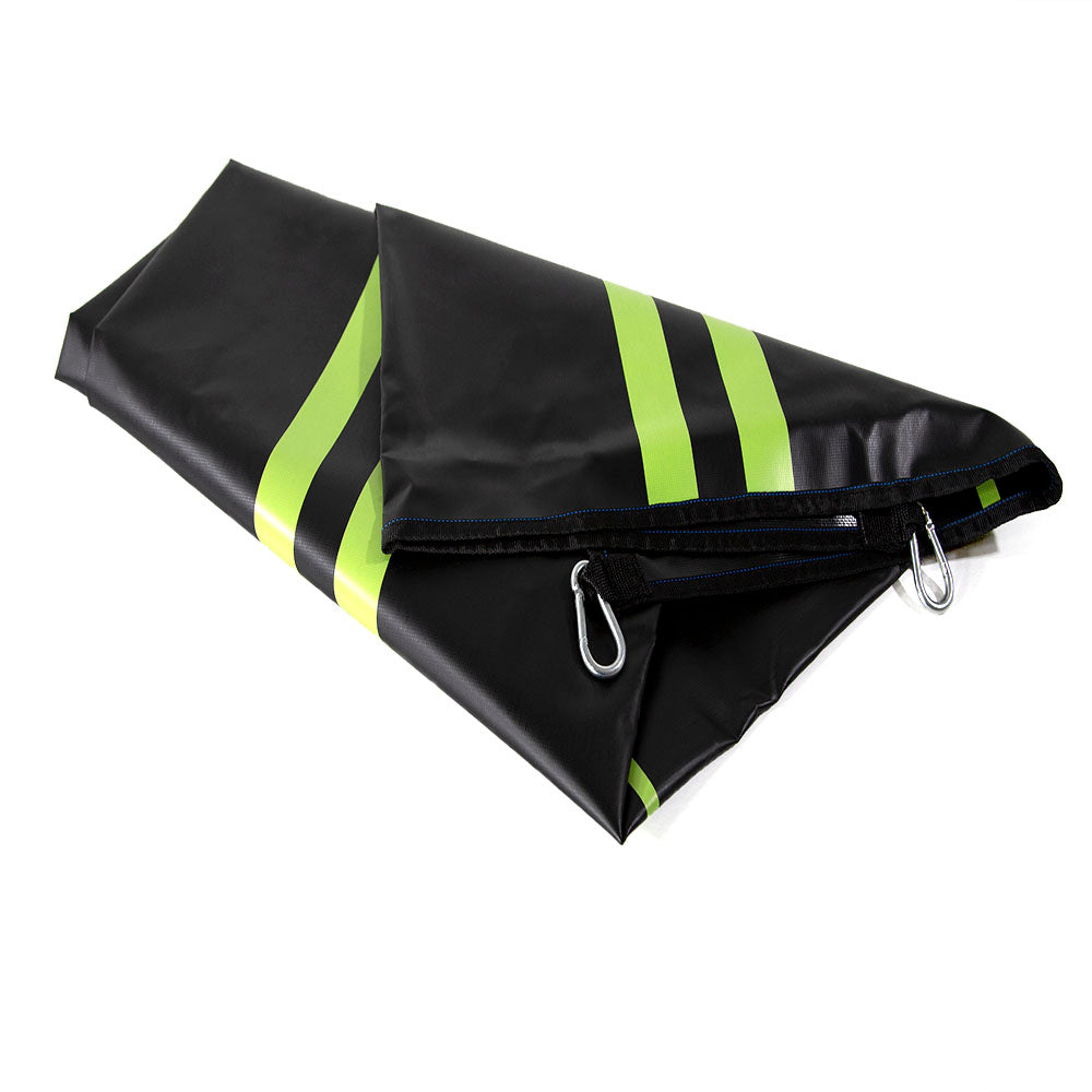 The folded target mat is black, lime green, and has blue stitching.