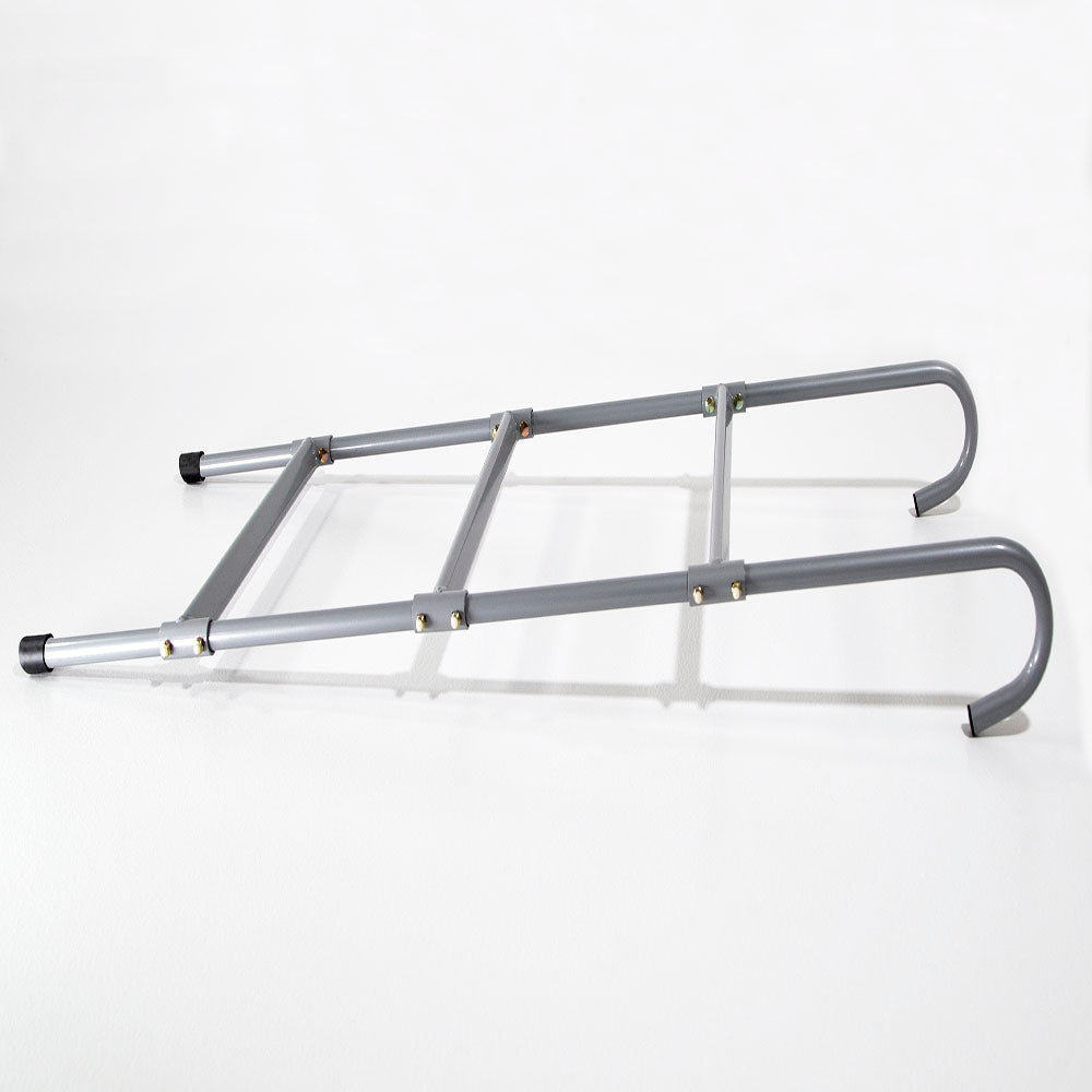 View of the trampoline ladder laying on the ground.