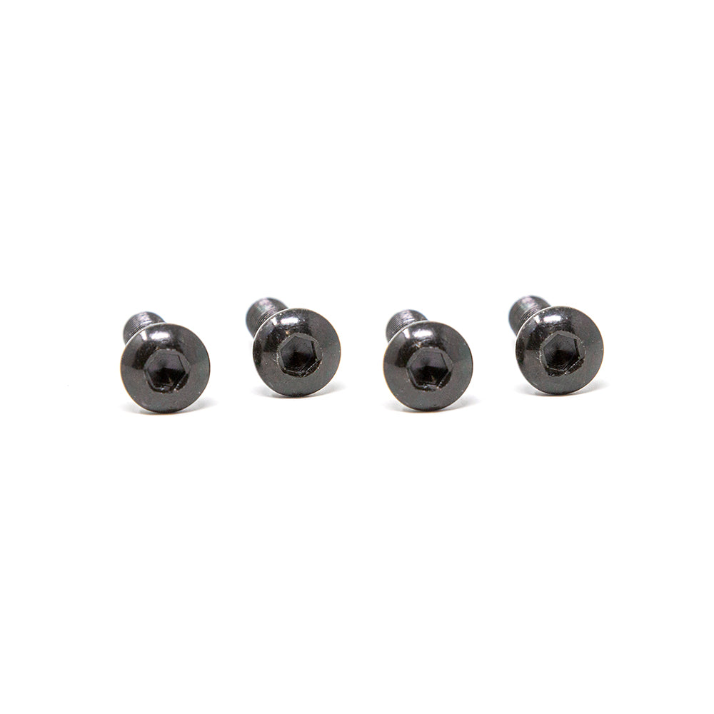 Four dark-colored button bolts lying in a row.