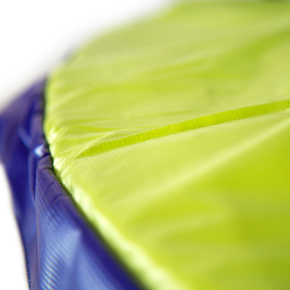 Close-up view of the bright blue and green spring pad.