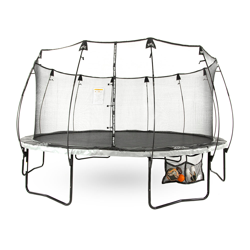 The Two Pocket Accessory Storage Bag is holding balls and a pair of shoes while strapped to the trampoline.