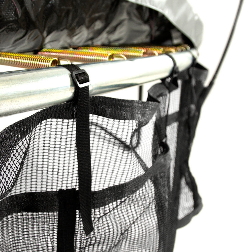 Spring pad is lifted up to show how the Three Pocket Accessory Storage Bag is strapped on the trampoline frame.