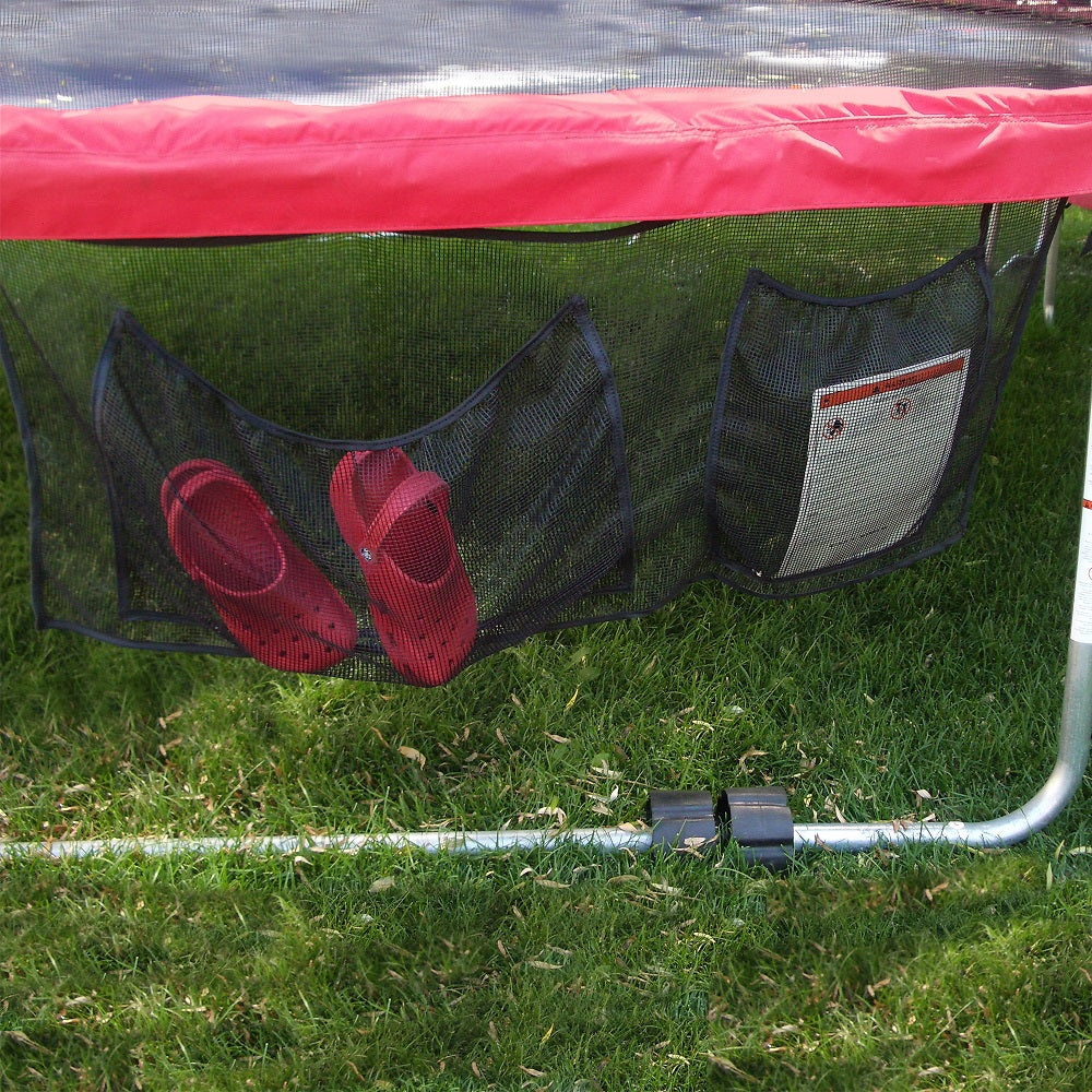 The shoe bag is attached to the edge of the trampoline.