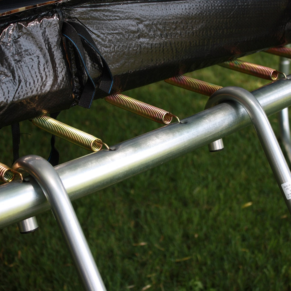 Close-up view of the trampoline ladder hooked onto the trampoline's steel frame. 