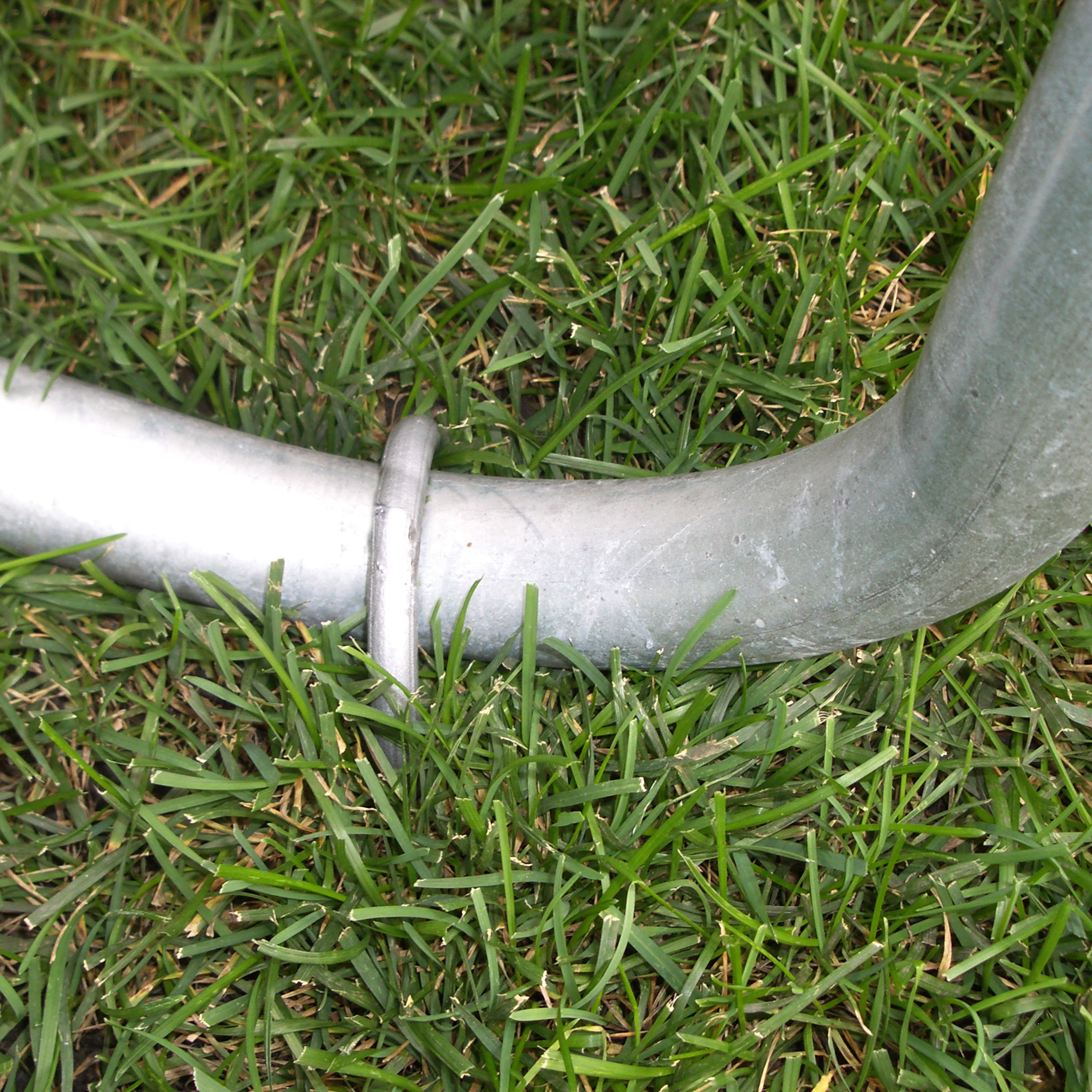 Wind stake is put on top of trampoline leg to keep it in place.