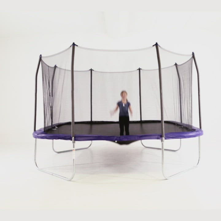 Two young girls bouncing high on the 14-footsquare trampoline. 