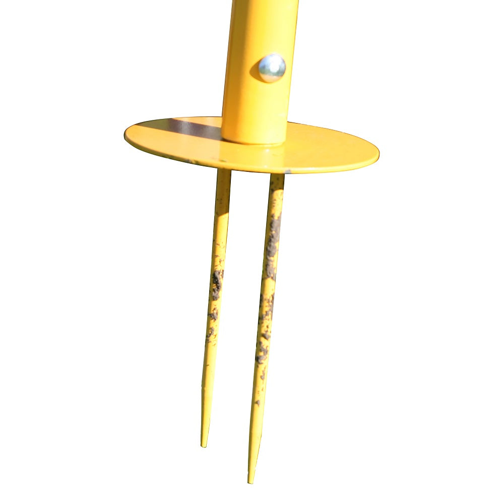 Yellow stake to secure the volleyball net into the ground on one side.