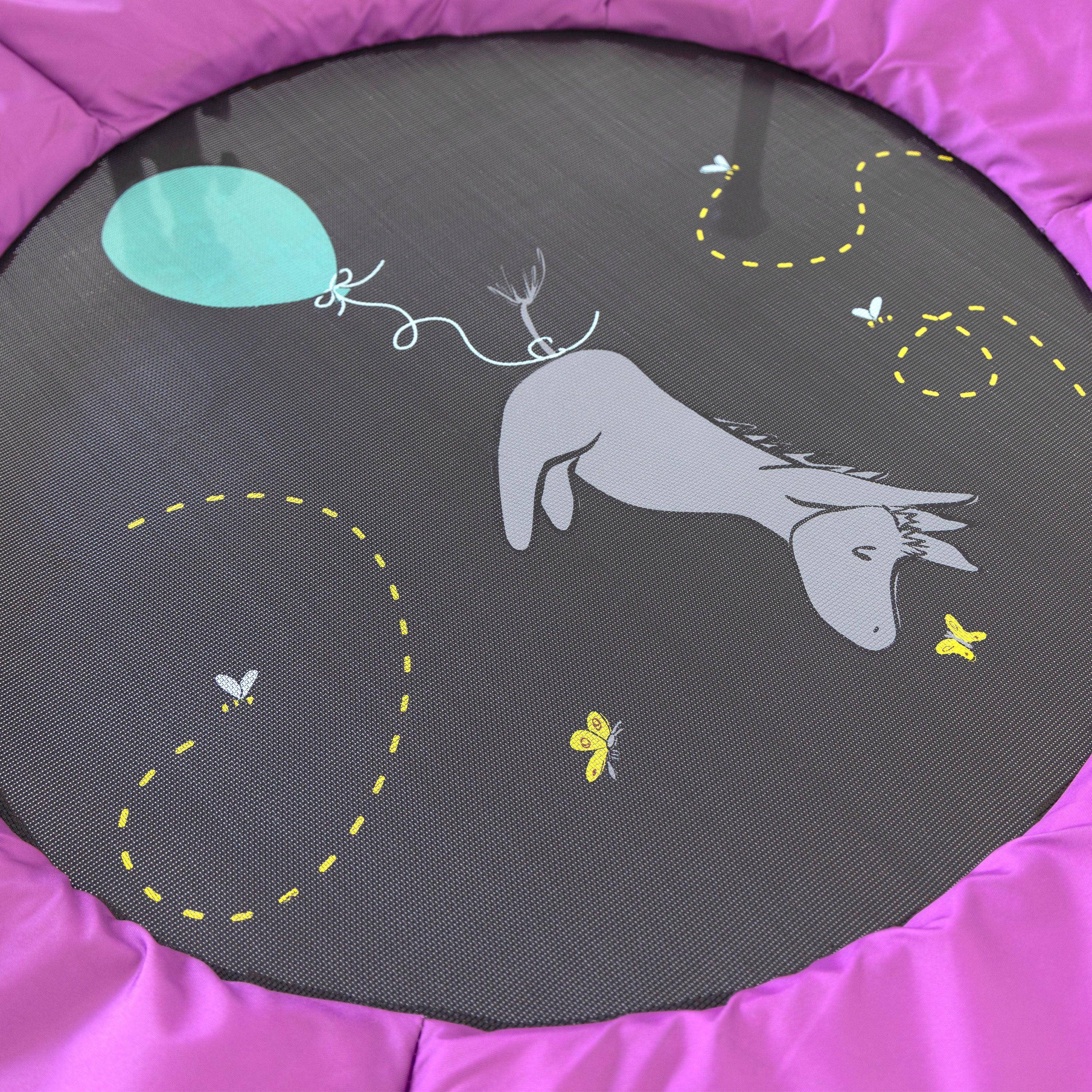 A vintage Eeyore is printed on the jump mat along with a blue balloon and yellow butterflies and honeybees. 