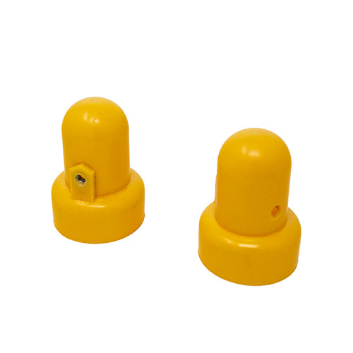 Two yellow pole caps sitting next to each other. 