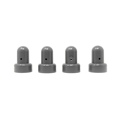 Four small grey pole caps with one pole cap facing the opposite direction of the others.