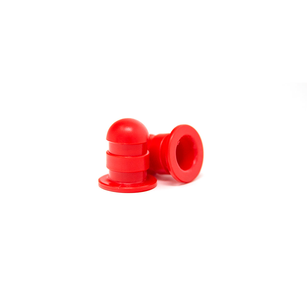 Small red pole caps designed for mini trampolines. 
