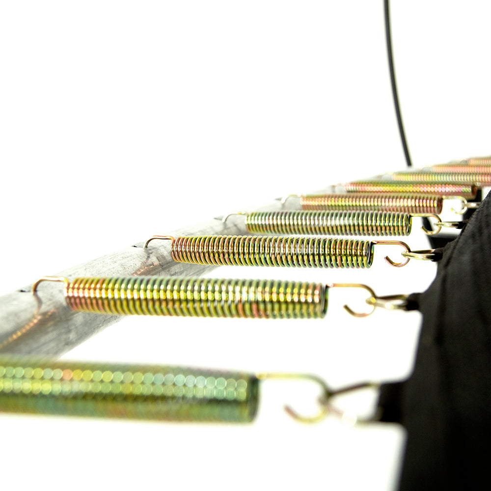 Shiny golden-colored springs with a tight coil connecting the jump mat and enclosure to the trampoline frame. 