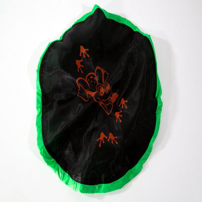 The black jump mat has an orange frog design printed on it and green trim around the edges. 