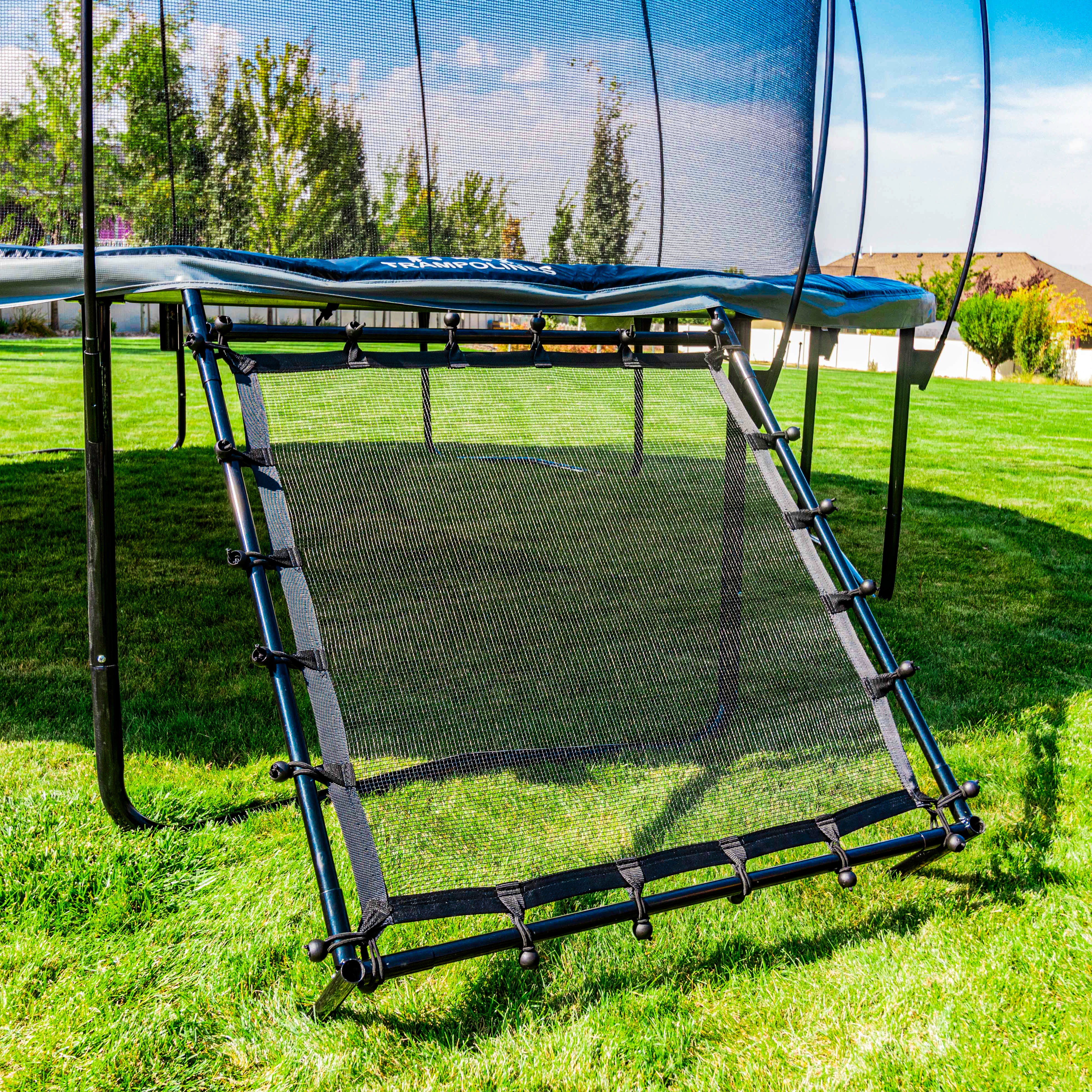 Half of the rebounder attaches to the frame of a trampoline.