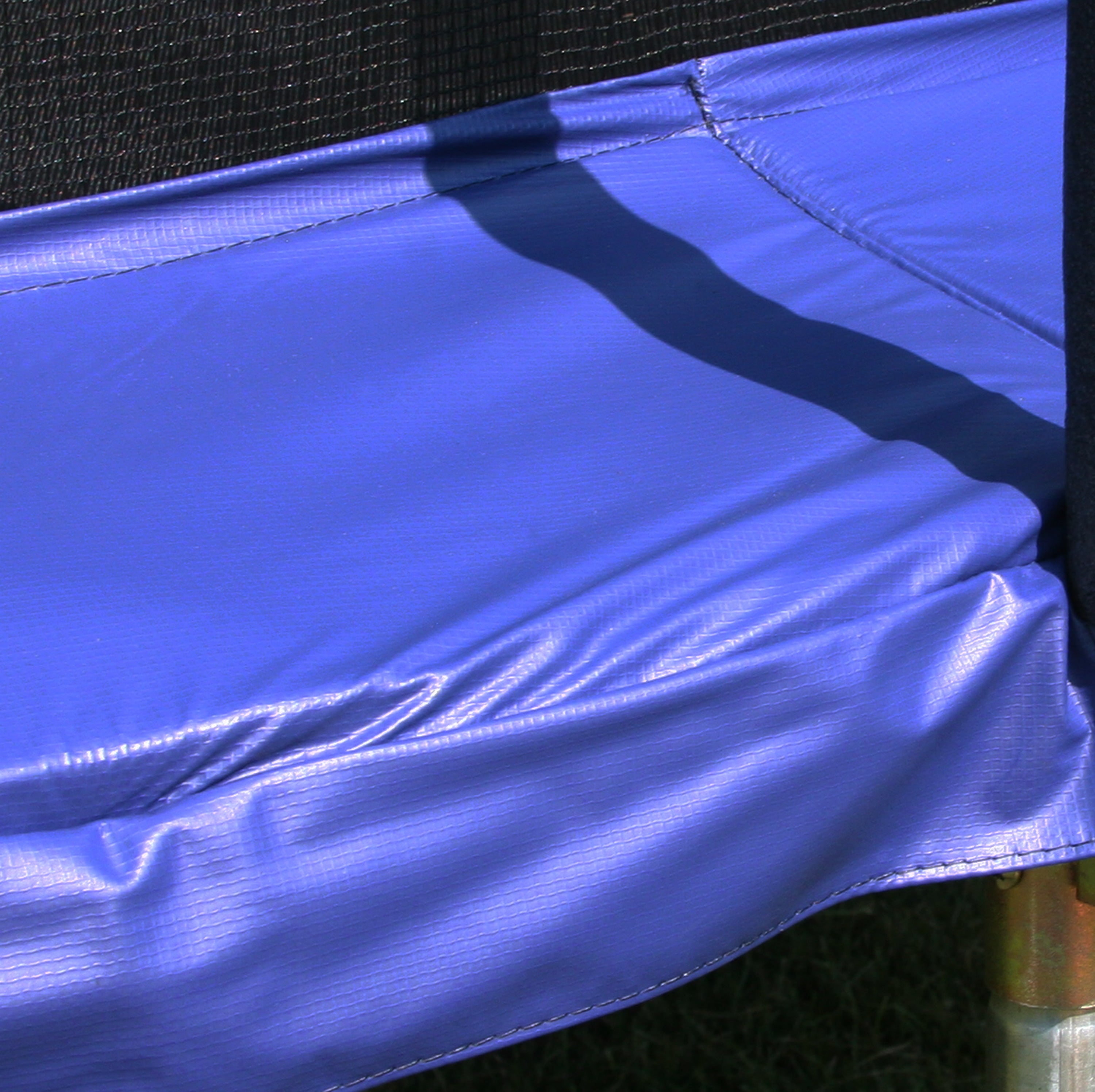 15-foot round blue spring pad as seen on a trampoline. 
