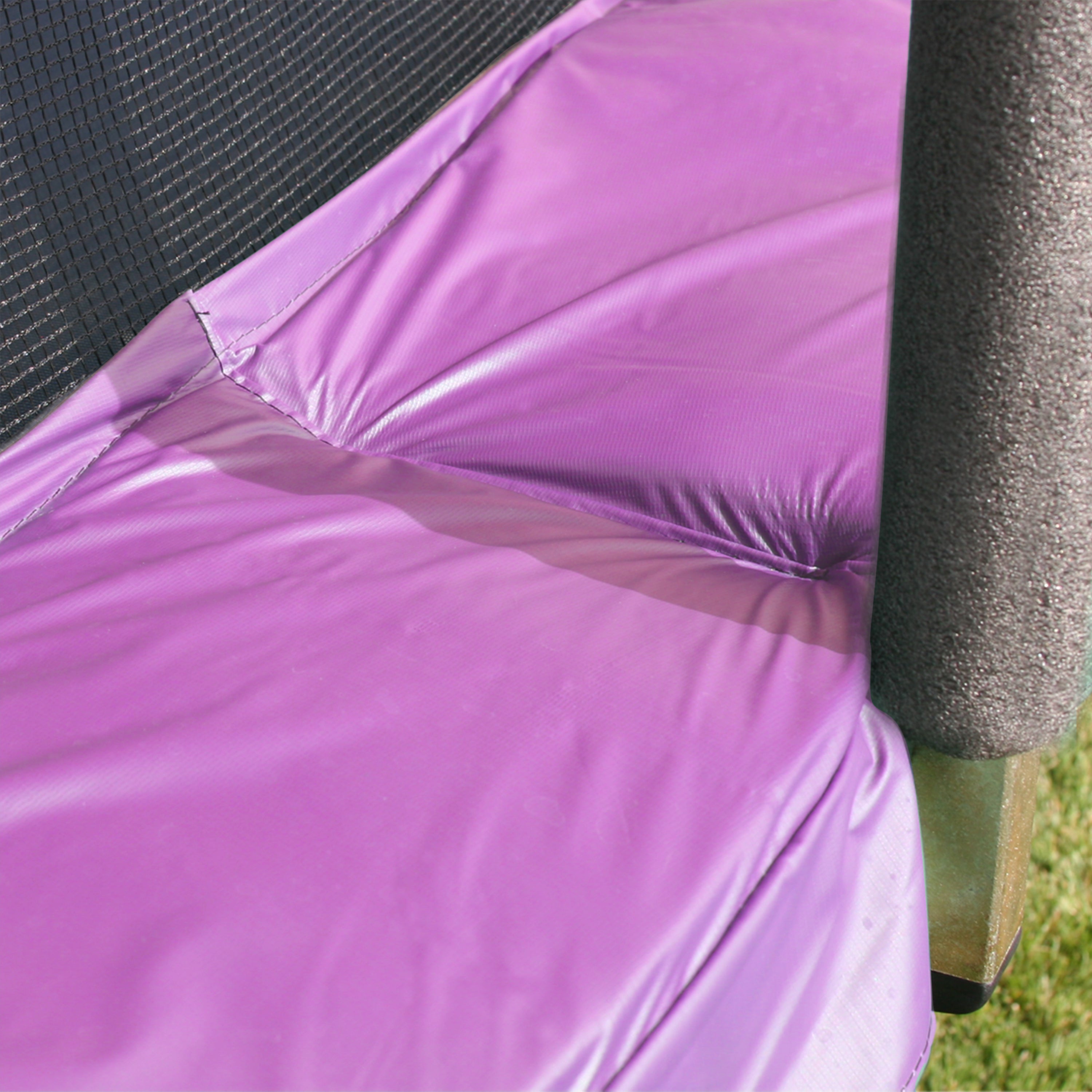 Purple spring pad covers the springs on the trampoline. 
