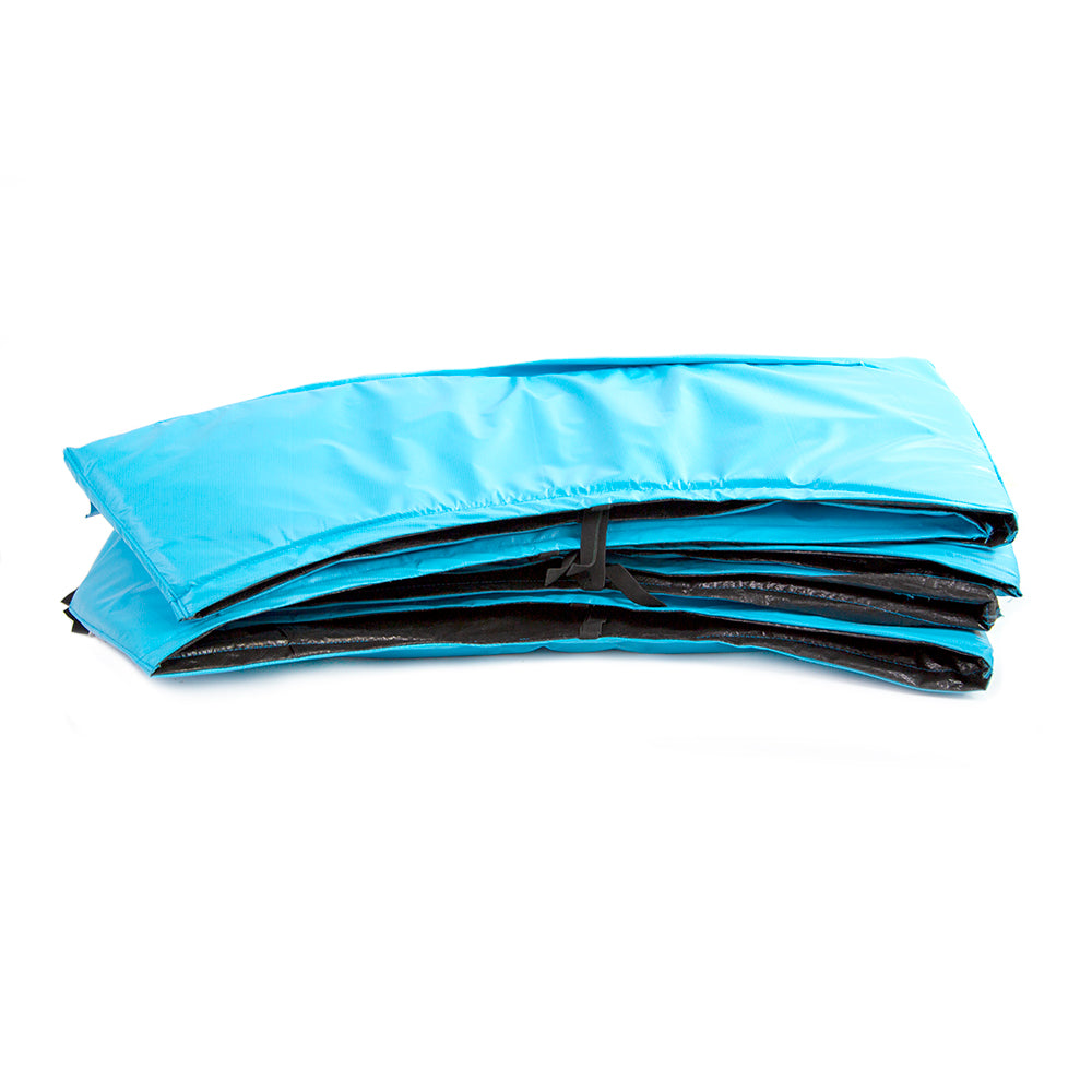 The teal spring pad has black straps to secure the pad to the trampoline frame. 