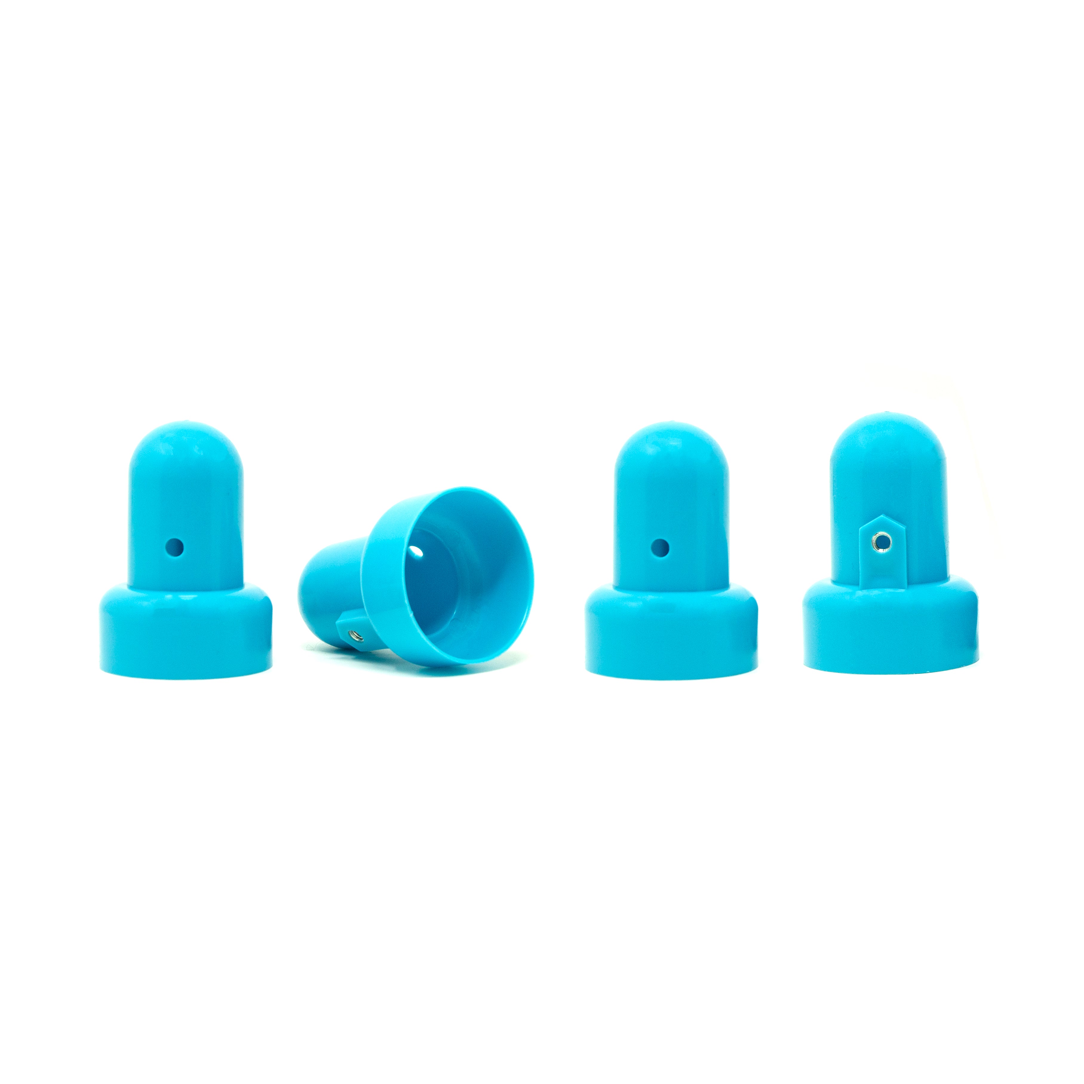 4 small, teal pole caps with one lying on its side. 