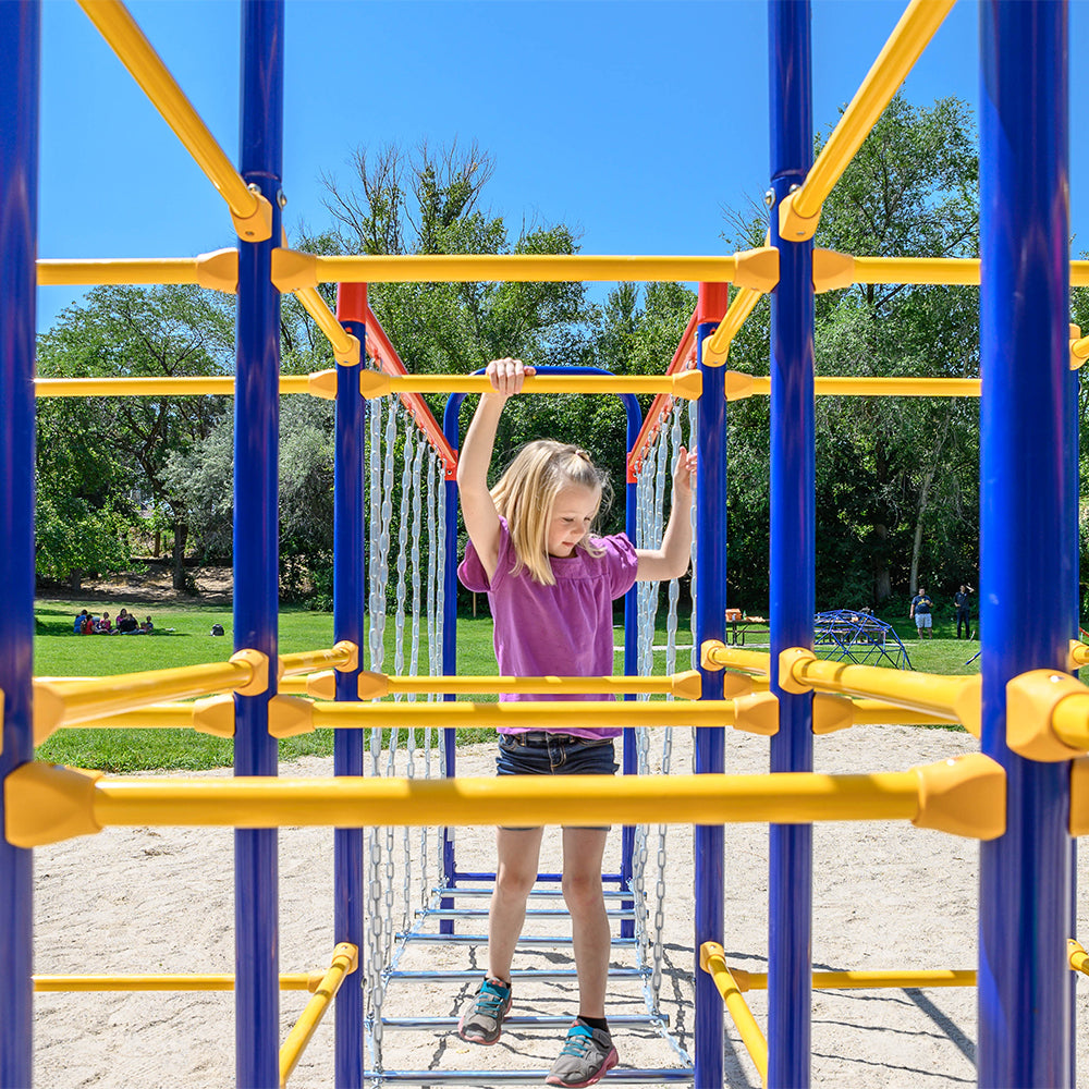 A young girl steps from the Hanging Bridge to the Modular Jungle Gym Base. 