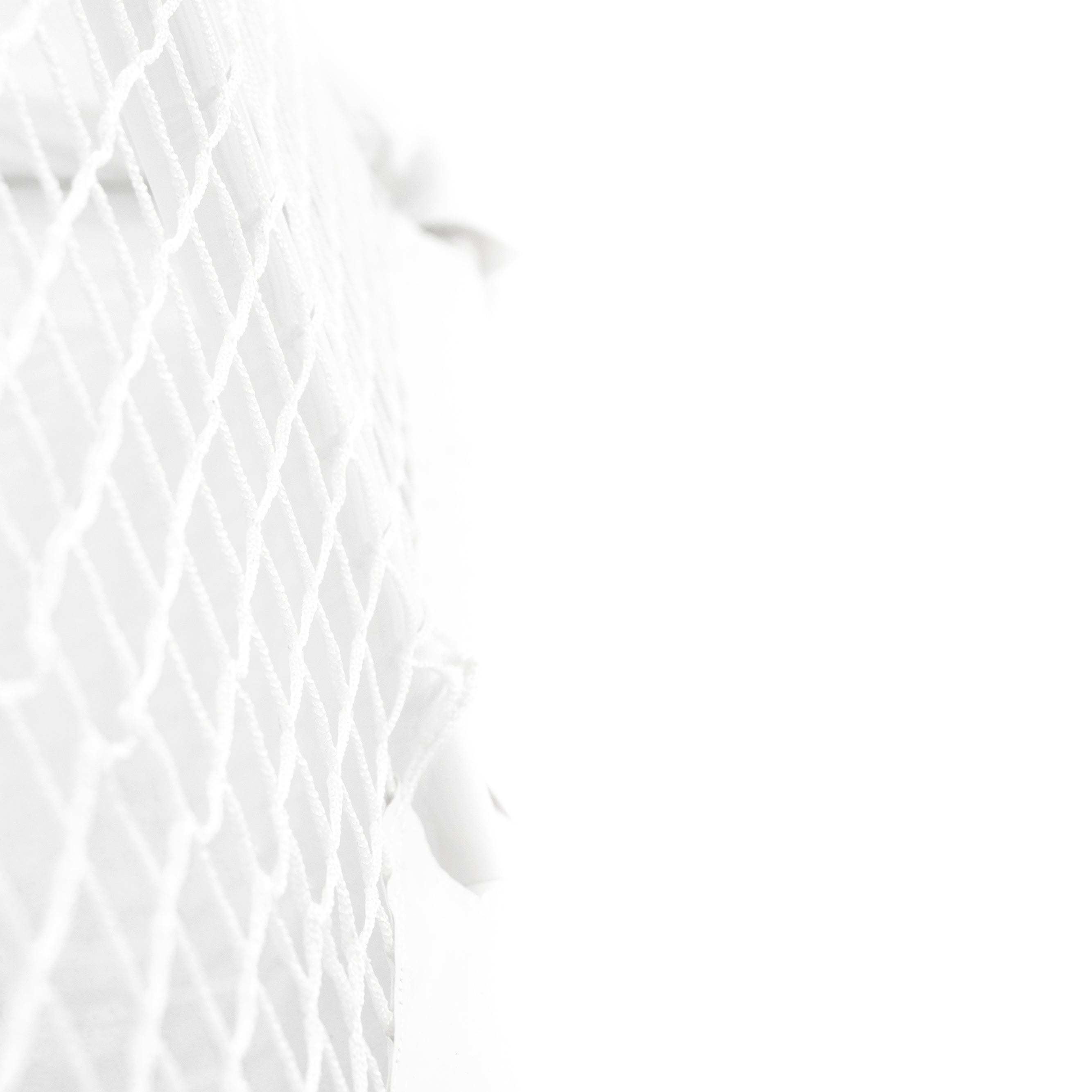 Close-up view of the hockey goal's white polyester net.