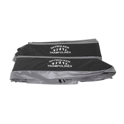 Black and gray spring pad with a white Skywalker Trampolines logo printed on it. 