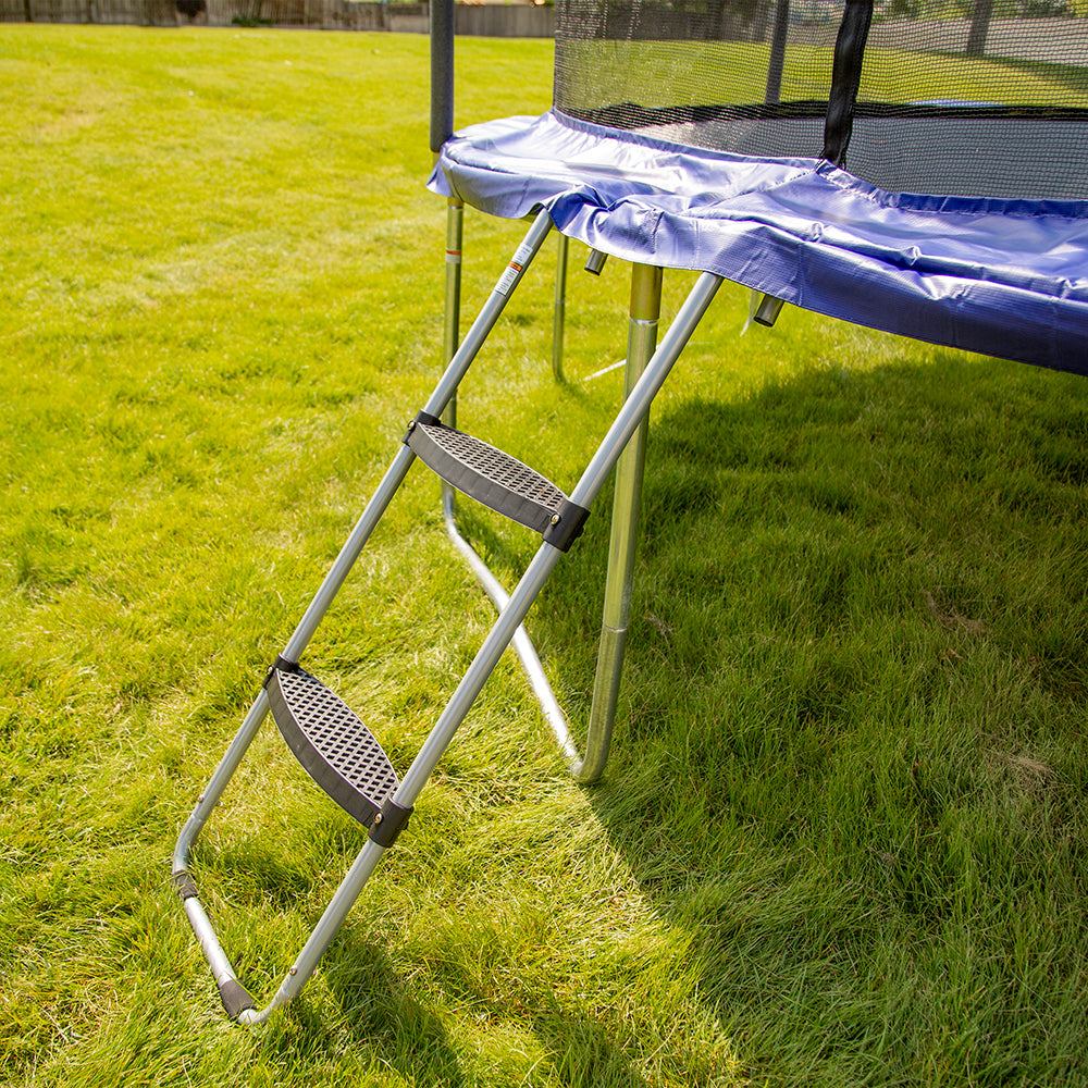 Side view of the two-rung plastic step ladder hooked onto a trampoline. 