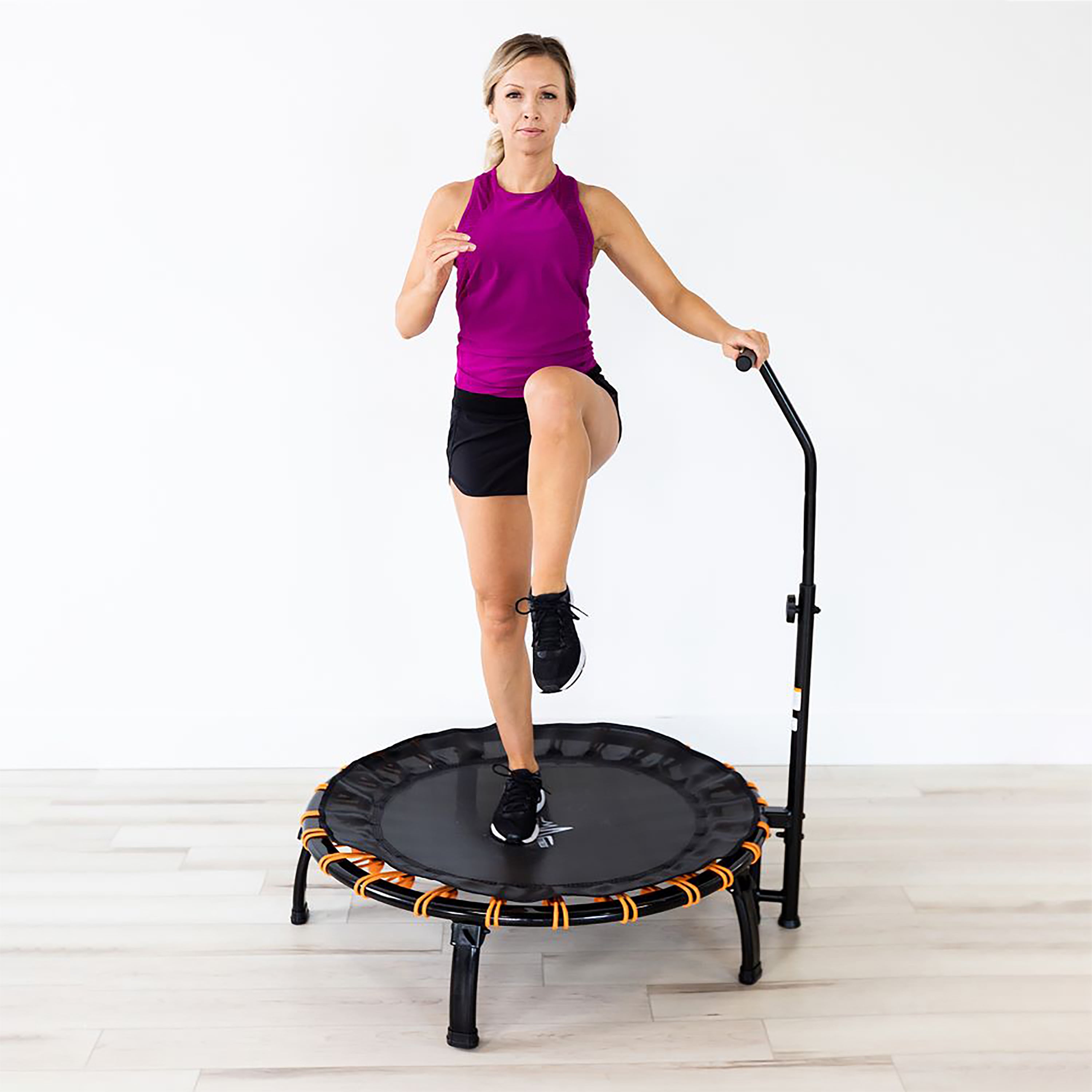 A woman balances on one leg on the SkyFitness 40" trampoline.