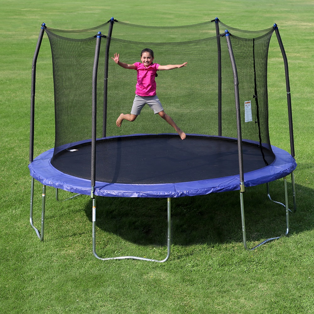Young girl excitedly jumping on a twelve-foot round kids trampoline with blue frame pad and blue pole caps. 