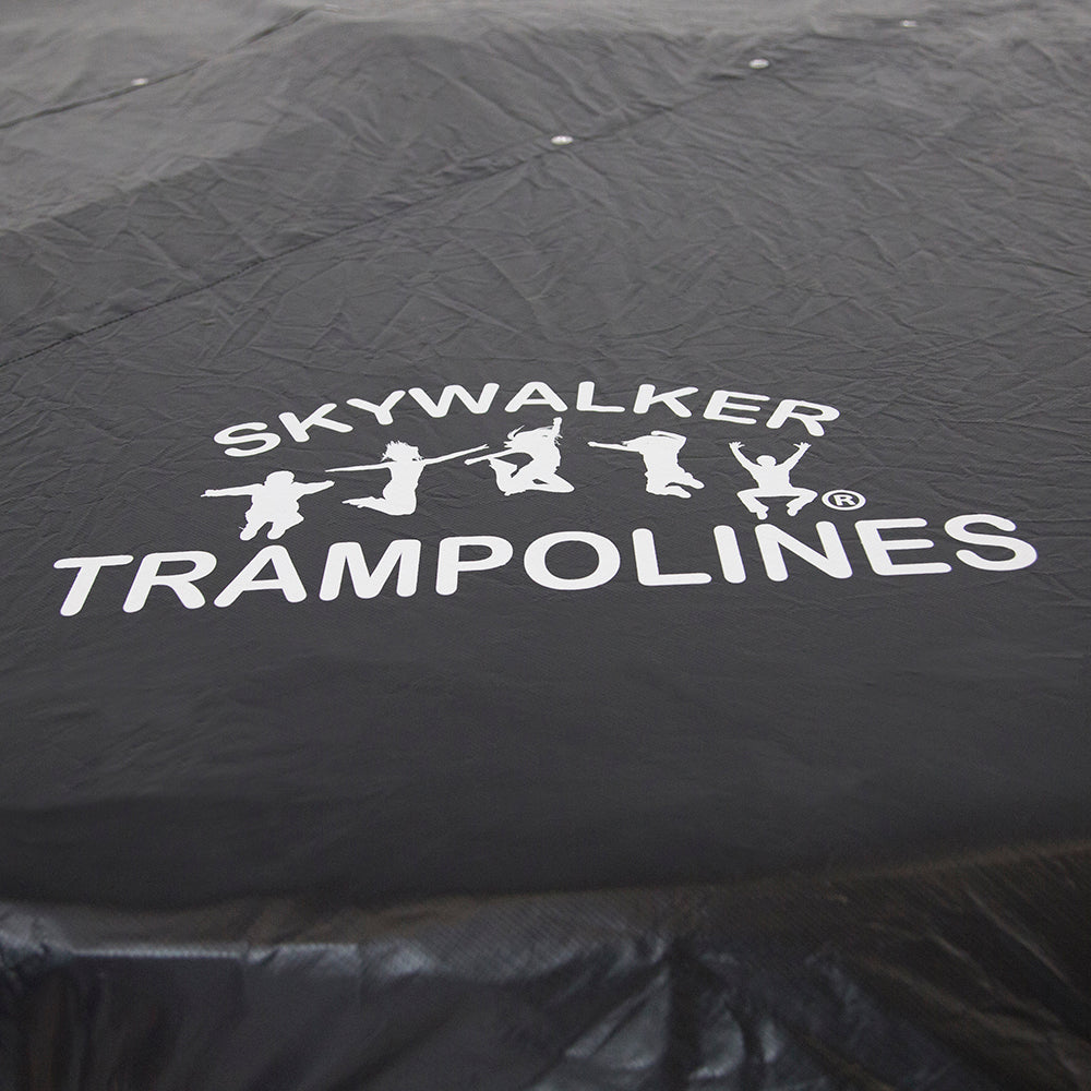 Closer view of the white Skywalker Trampolines logo on the black weather cover. 