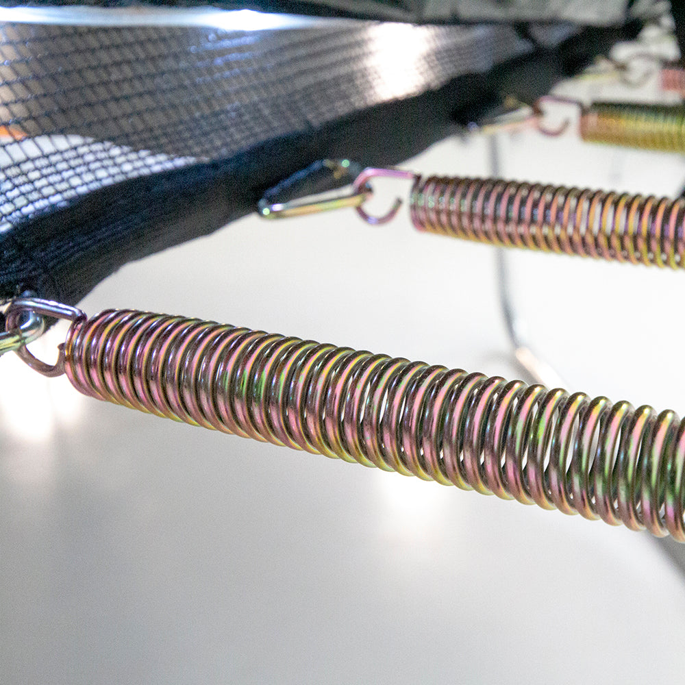 Shiny springs are connected to the black enclosure net with v-rings while the LED lights shine down on them. 