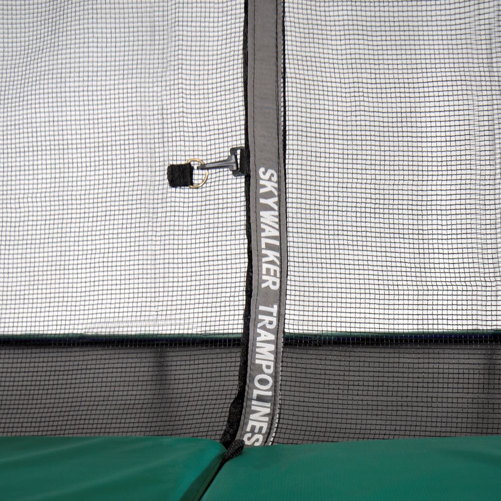 The zipper on the enclosure net reads, "Skywalker Trampolines" in white font. 